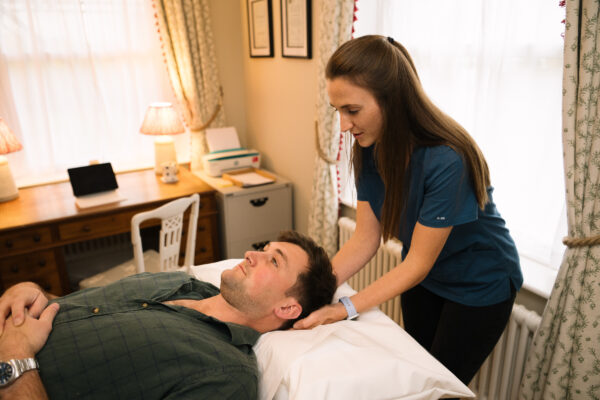Osteopath treating headache