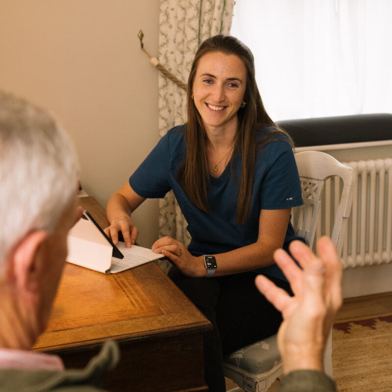 Evie Muir talking to an osteopathy patient