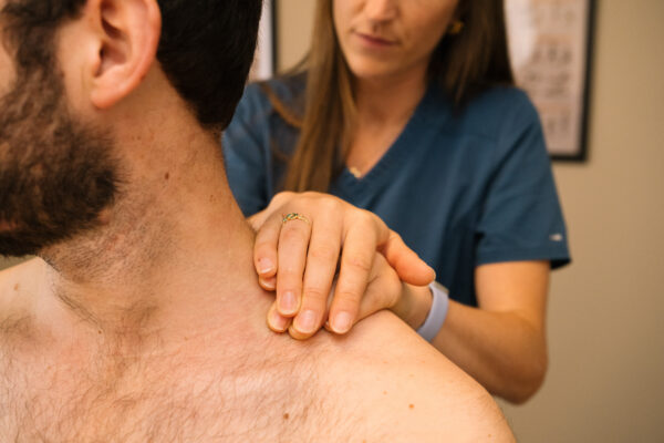 Close up of osteopath treating shoulder